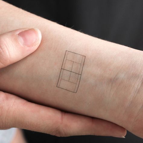 a person's arm with a tattoo on it that has a square in the middle