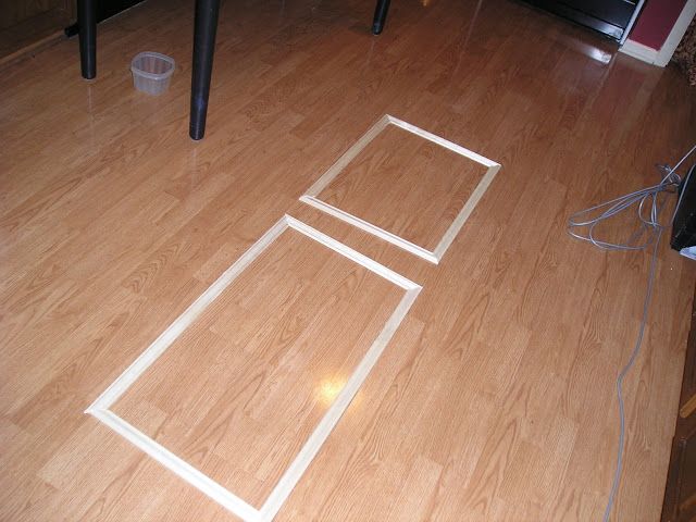 the floor is made out of wood and has white lines drawn on it with tape