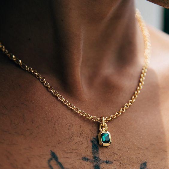 The one you didn't know you've been searching for. This necklace was created with versatility in mind, with a mix of two chains giving it a contemporary twist. Abel has a mix of 2 different gold chain styles, delicately finished off with our signature emerald pendant. All of our 18k gold or silver plated jewellery should be stored in a cool, dry place and cleaned carefully with a soft non-abrasive cloth to maintain shine.Our pieces also contain real glass stones, cubic zirconia or freshwater pea Emerald Pendant Men, Mens Necklace Gold Pendant, Emerald Pendant For Men, Emerald Jewelry For Men, Man Necklace Aesthetic, Gold Chain Brass Pendant Necklace, Gold Chain Pendant Necklace In Brass, Modern Jewelry With Square Pendant Chain, Modern Pendant Chain Necklace With Delicate Chain