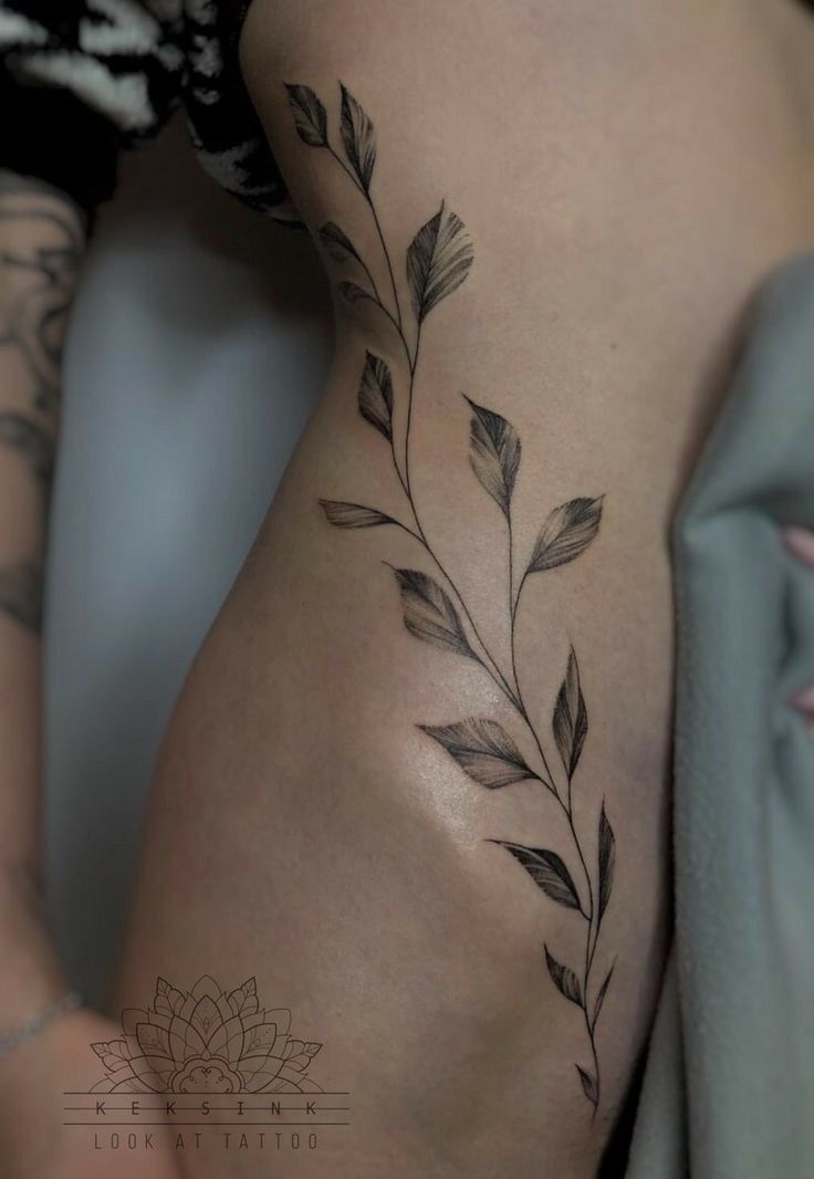 a woman's thigh with leaves on it