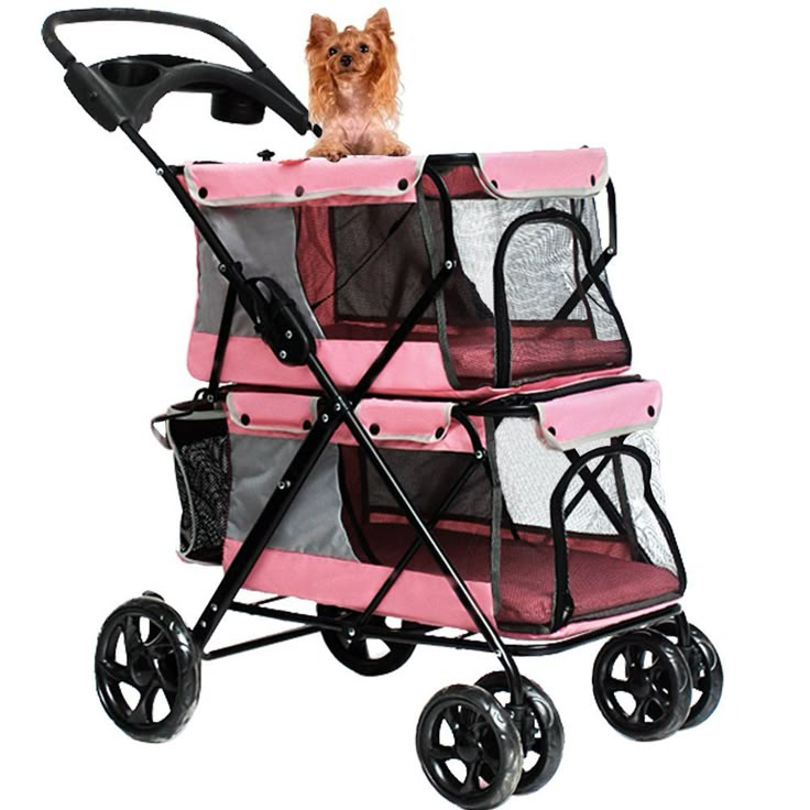 a small dog sitting on top of a pink stroller