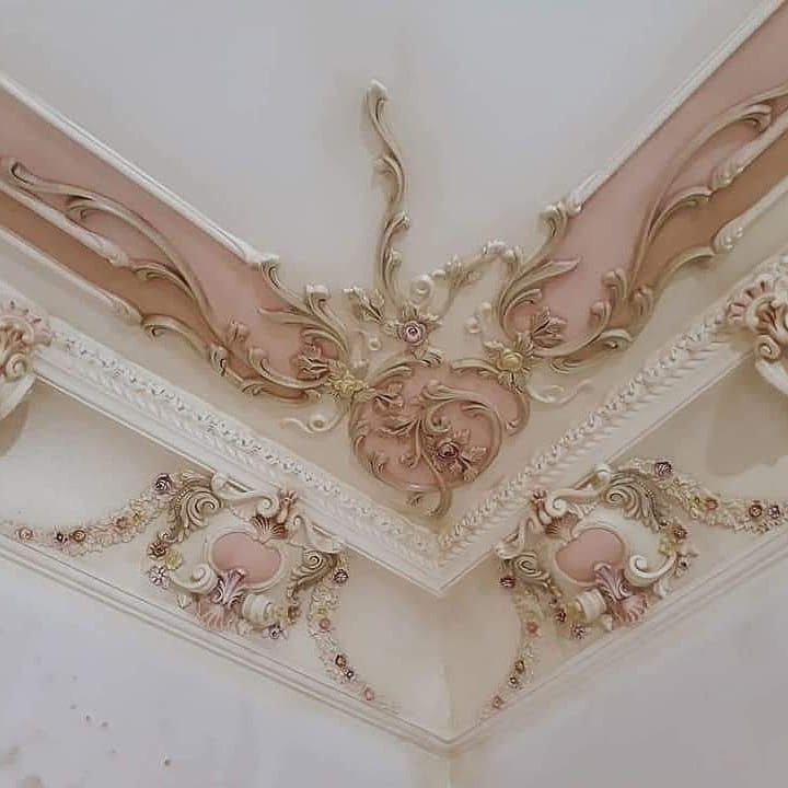 the ceiling is decorated in pink and gold