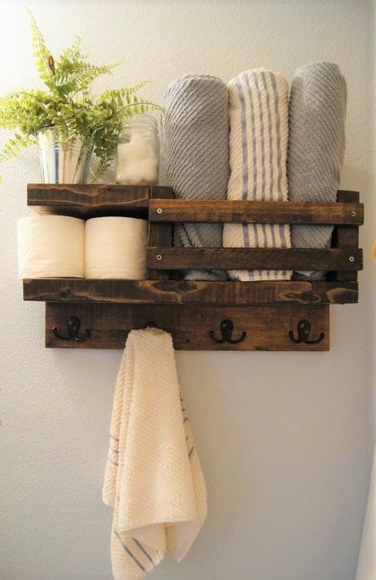 a bathroom shelf with towels and other items on it