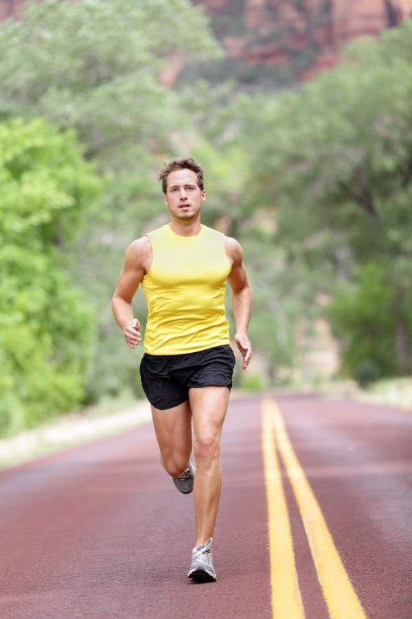 a man running down the middle of a road