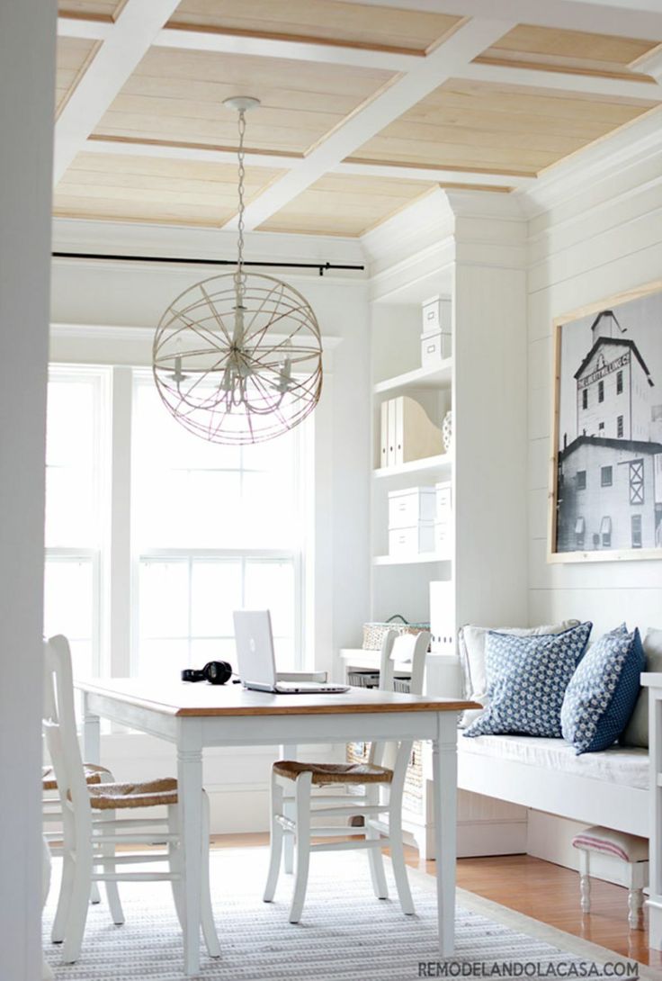 a dining room table with chairs and a laptop on it