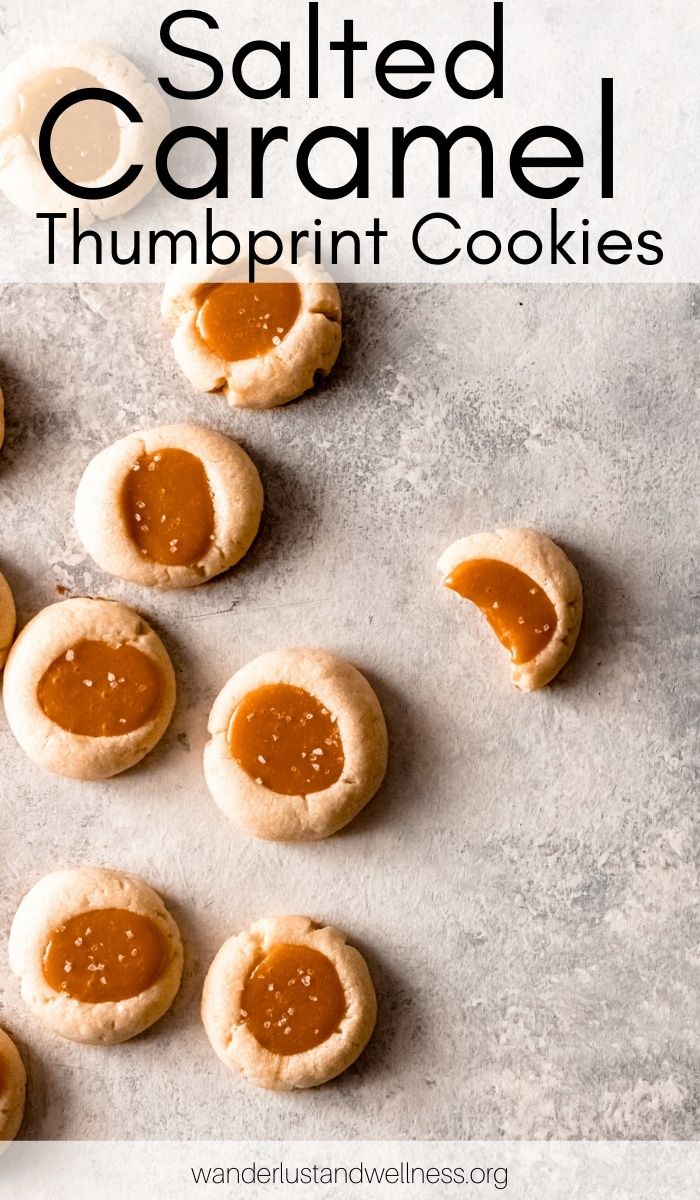 salted caramel thumbnut cookies on a baking sheet with text overlay that reads salted caramel thumbnut cookies