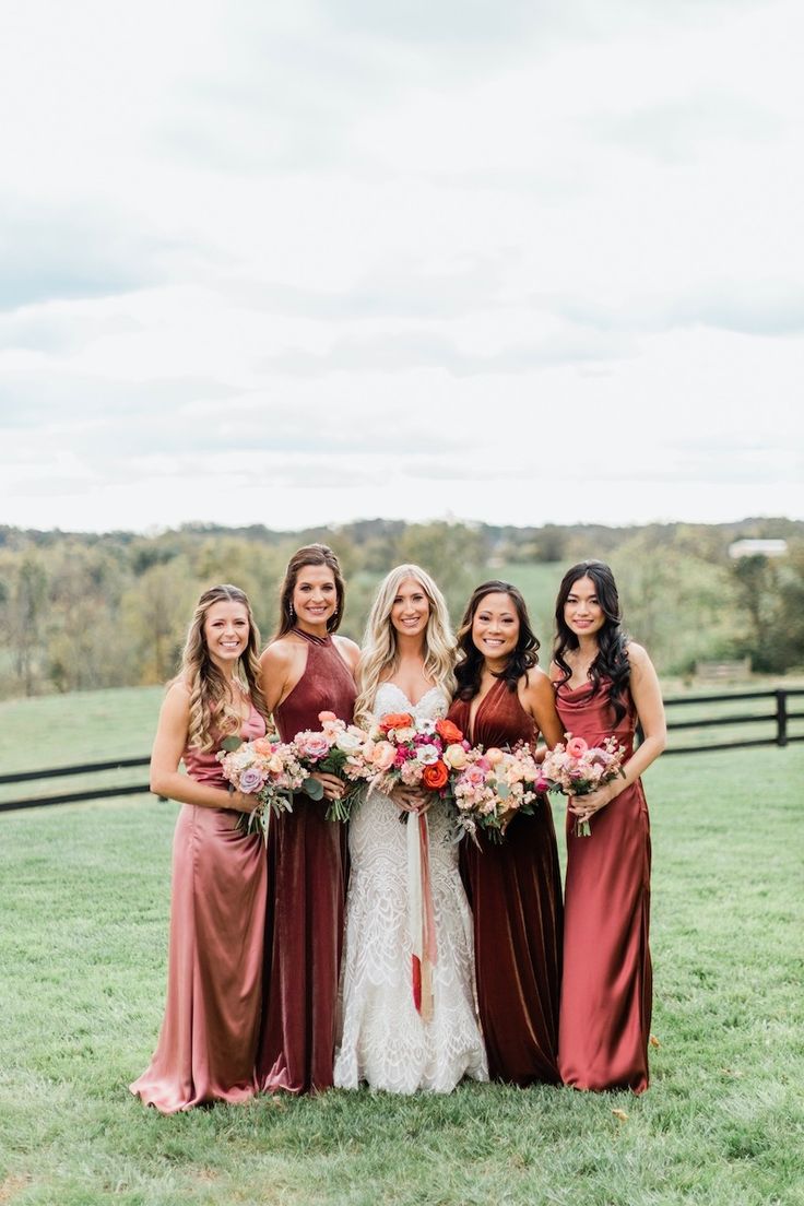 the bridesmaids are all dressed in burgundy dresses