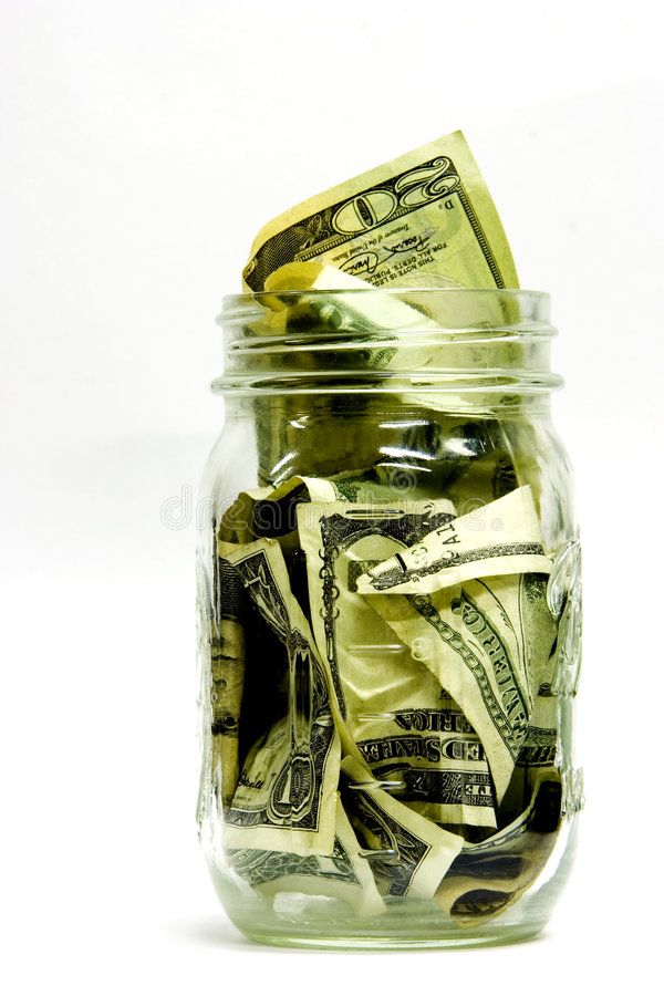 a jar filled with money sitting on top of a table