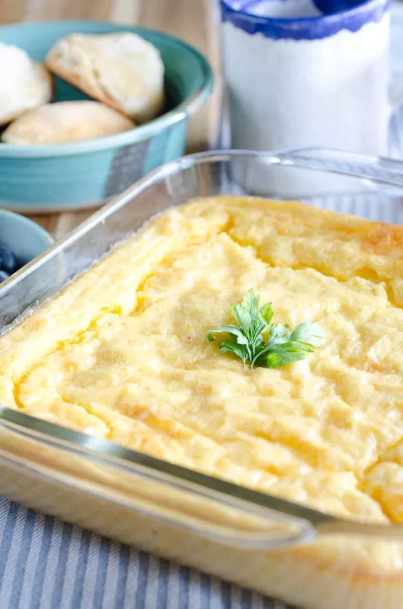 a casserole in a glass dish on a table with other dishes and utensils