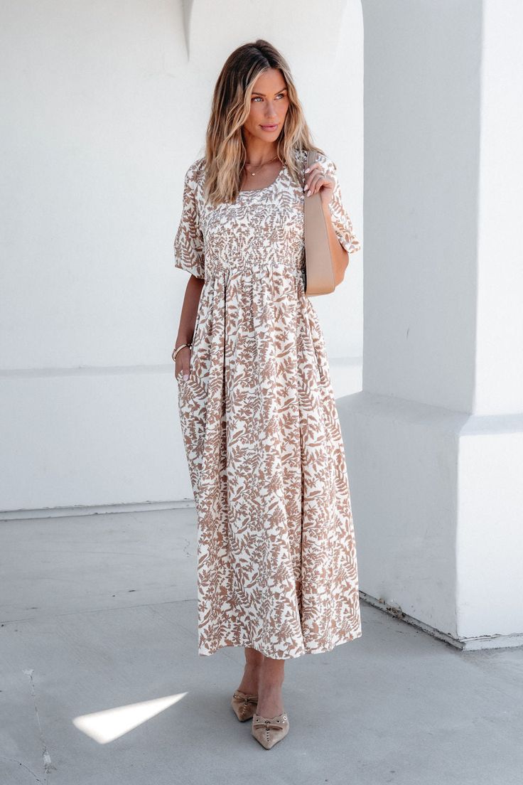 This darling maxi dress is perfect for any fall event! This Cream Print Smocked Maxi Dress features a flattering smocked waist and short puff sleeves for a feminine touch. The scoop neckline and back self-tie closure add elegant detail, while the allover print adds a pop of color. With the added convenience of side pockets and partial lining, this dress combines style and functionality. Style with strappy heels and a matching crossbody bag for an elevated boho chic look! Sorority Rush Outfits, Rush Outfits, Smocked Maxi Dress, Gameday Dress, Loungewear Dresses, Casual White Dress, Family Photo Outfits, Game Dresses, Family Photo