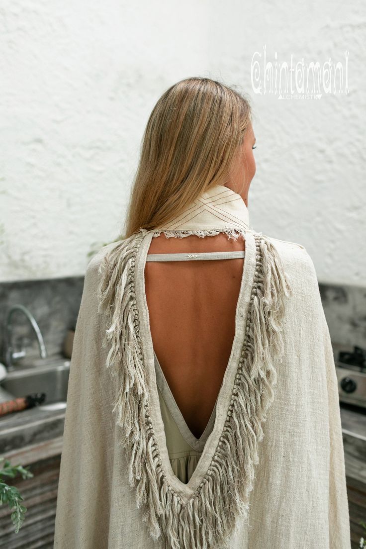 Cotton Open Back Poncho is a very original designer garment to compliment your boho outfit on a cool summer evening. High cotton canvas collar is reminiscent of elegant XIX century lady cloak, while long gorgeous linen fringe on the hemline brings an ultimate boho touch to the piece. The back of the poncho is open and also decorated with the statement fringes of our Alma Libra collection. It is made of 100% natural raw and very soft cotton. In hot climate you can wear this Poncho with our open b Bohemian Wrap Poncho For Festivals, Bohemian Poncho For Festivals, Bohemian Shawl Poncho, Poncho Women, Fringe Cape, Organic Clothing Women, Cape Top, Boho Poncho, Boho Shawl