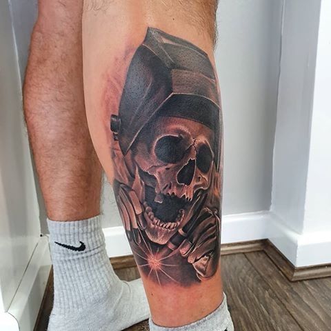 a man with a skull tattoo on his leg