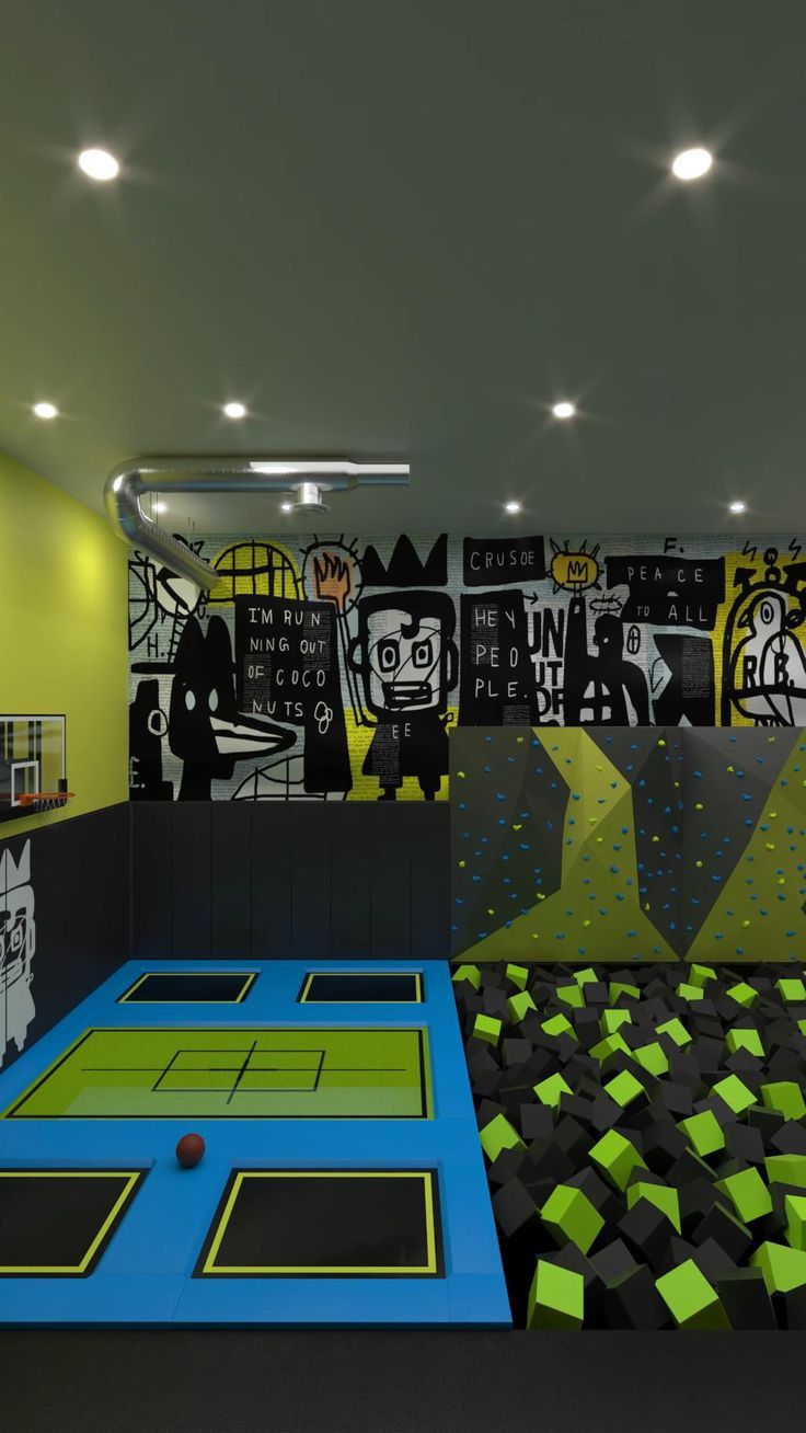 an indoor play area with black, yellow and green tiles on the walls is shown