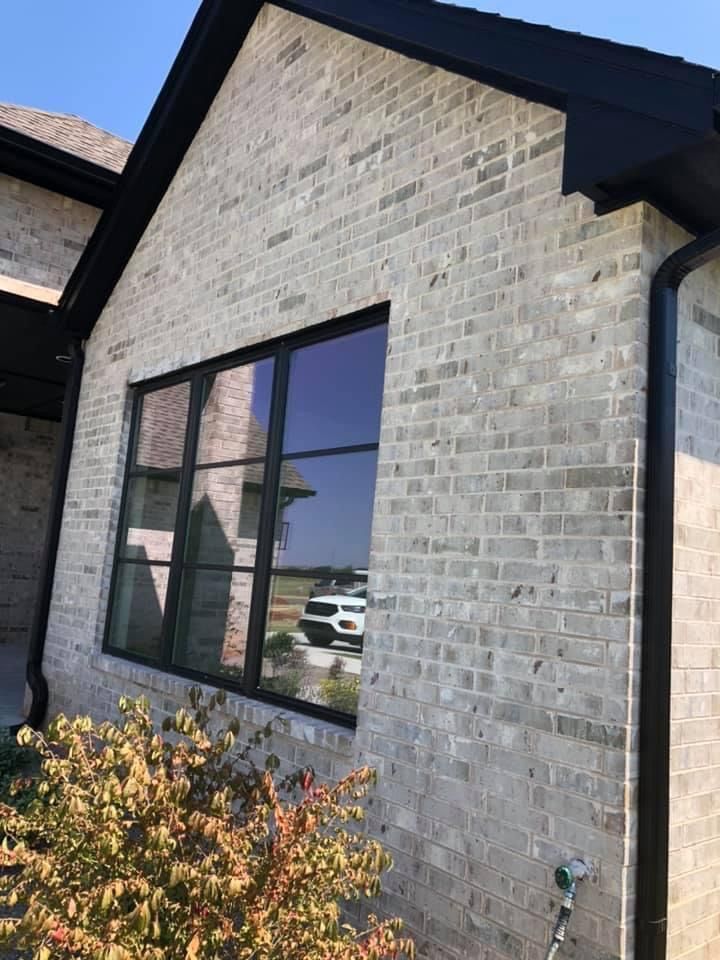 a brick building with a car parked in front of it and a window on the side