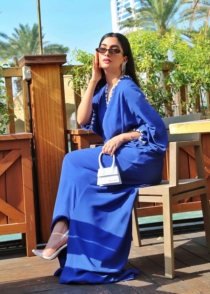 Azure blue georgette silk kaftan with details on the neckline, sleeves and back. Elegant Blue Maxi Dress With Draped Sleeves, Blue Silk V-neck Kaftan, Blue V-neck Kaftan For Party, Elegant Blue Long Sleeve Abaya, Elegant Long Sleeve Blue Abaya, Elegant Blue Maxi Abaya, Elegant Blue Maxi Length Abaya, Blue Long Sleeve Kaftan For Party, Elegant Long Blue Abaya