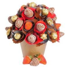 a bouquet of chocolates and strawberries in a vase