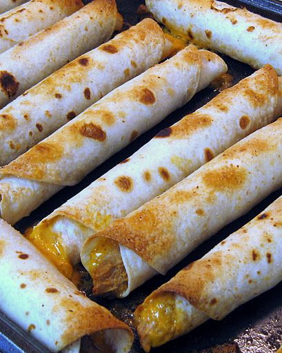 several burritos are being cooked in a pan on the stove with peppers and cheese