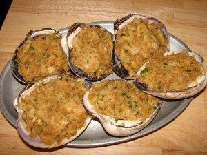 an assortment of baked food items on a metal platter with wood table in the background