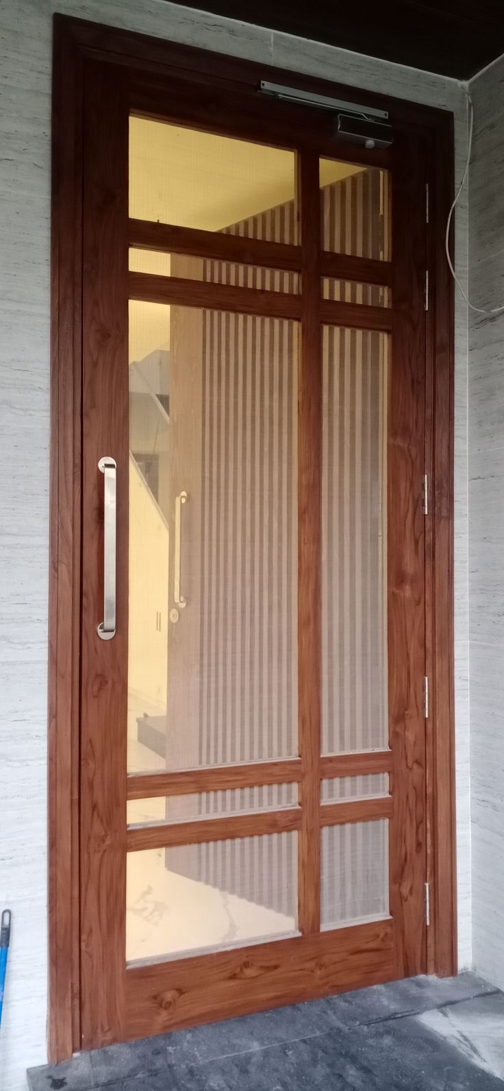 a wooden door with glass panels on the outside