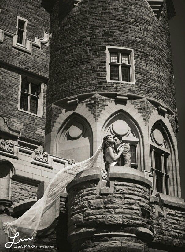 black and white photograph of a woman in front of a castle