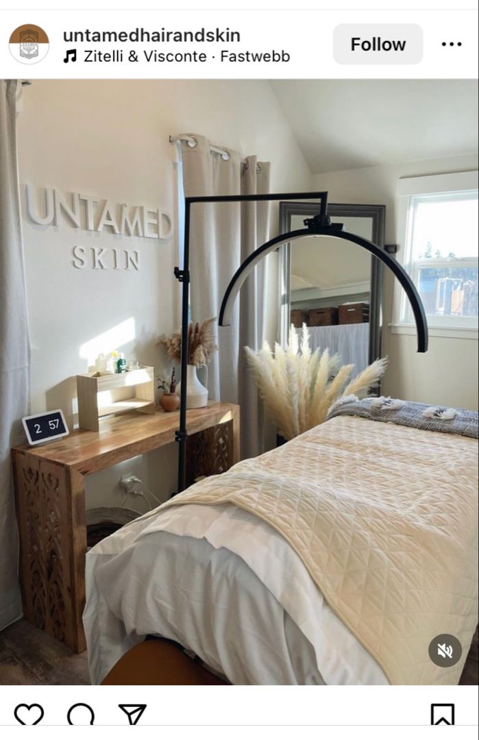 a bedroom with a bed, dresser and mirror on the wall next to it's windows