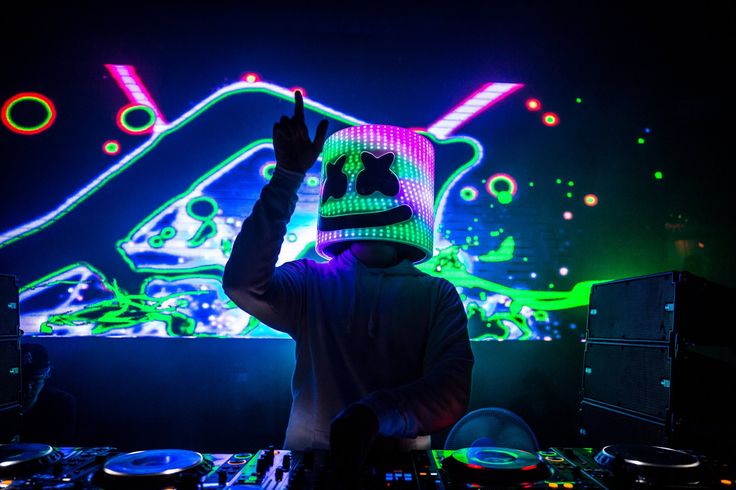 a dj mixing in front of colorful lights