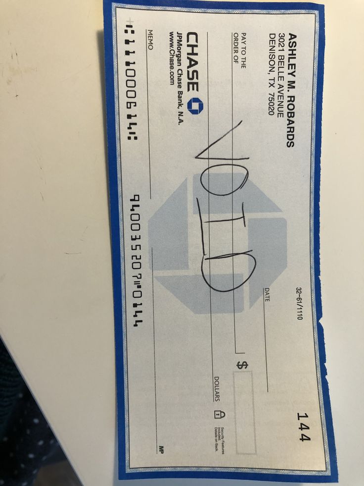 a cheque is hanging on the side of a refrigerator freezer with blue tape