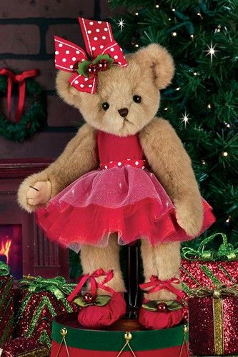 a teddy bear dressed in a red tutu and pink dress standing next to presents