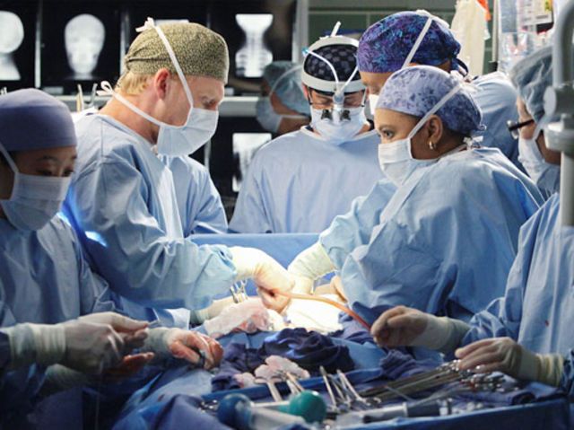 a group of doctors performing surgery in an operating room