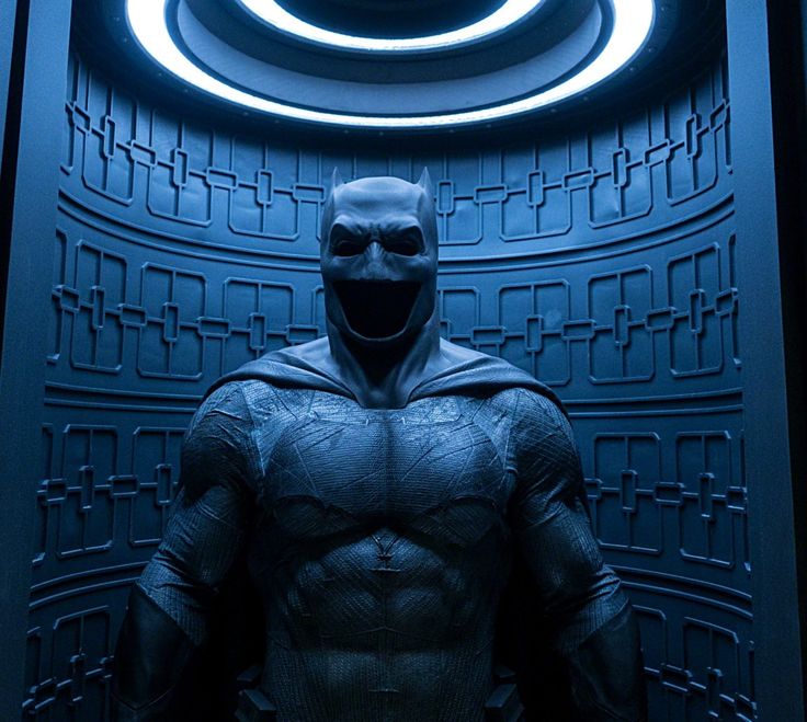 the dark knight is standing in front of a circular doorway