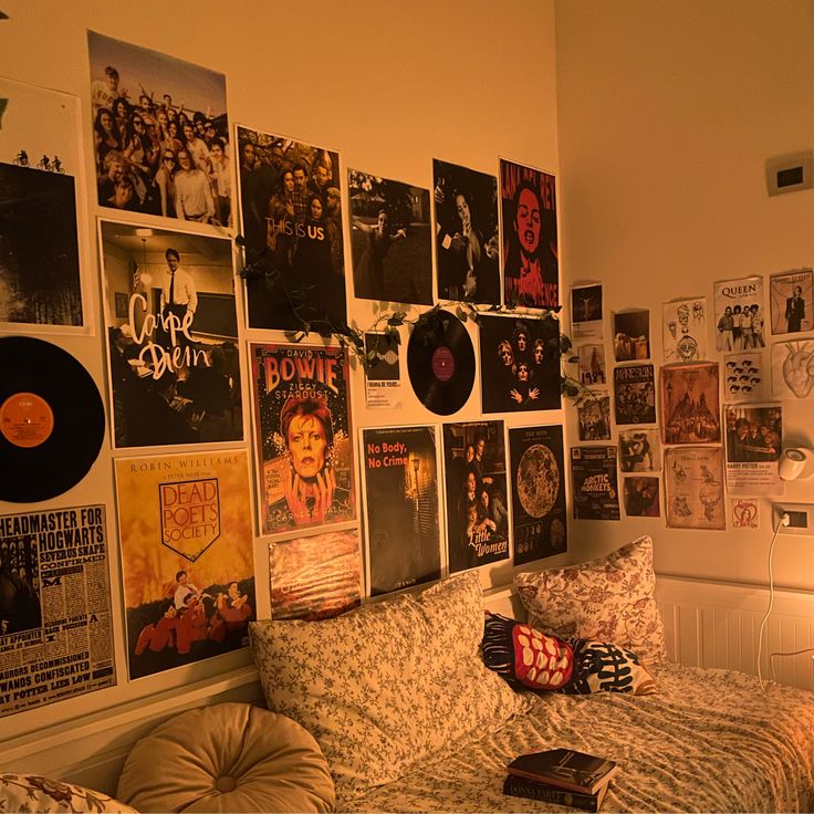 a bed with lots of records on the wall