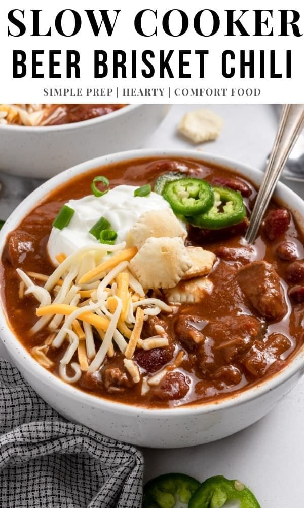 two bowls of slow cooker beef brisket chili with cheese and jalapenos