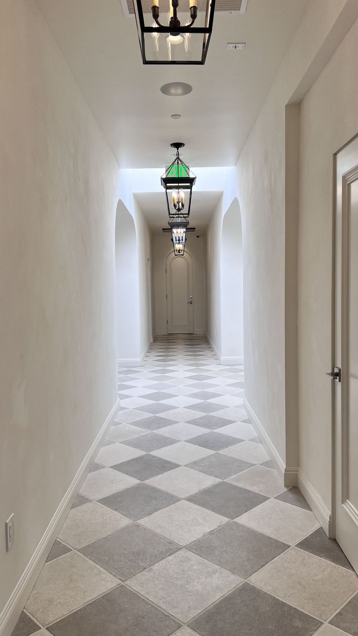 an empty hallway with a lantern hanging from the ceiling