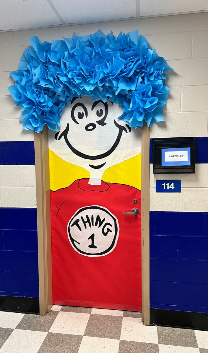 a door decorated with blue paper flowers and a dr seuss thing on the front