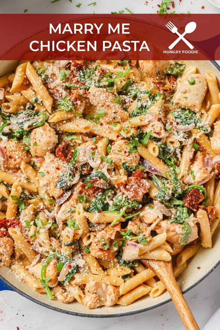 a pasta dish with chicken and spinach in a skillet on top of a table