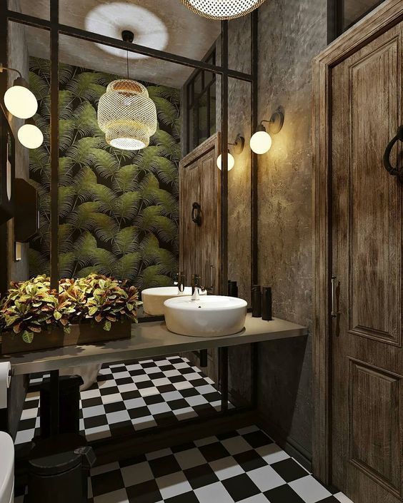 a bathroom with black and white checkered flooring, two sinks and large mirrors