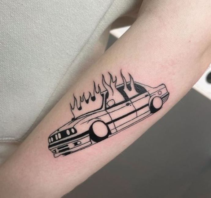 a black and white photo of a car with flames on it's side arm