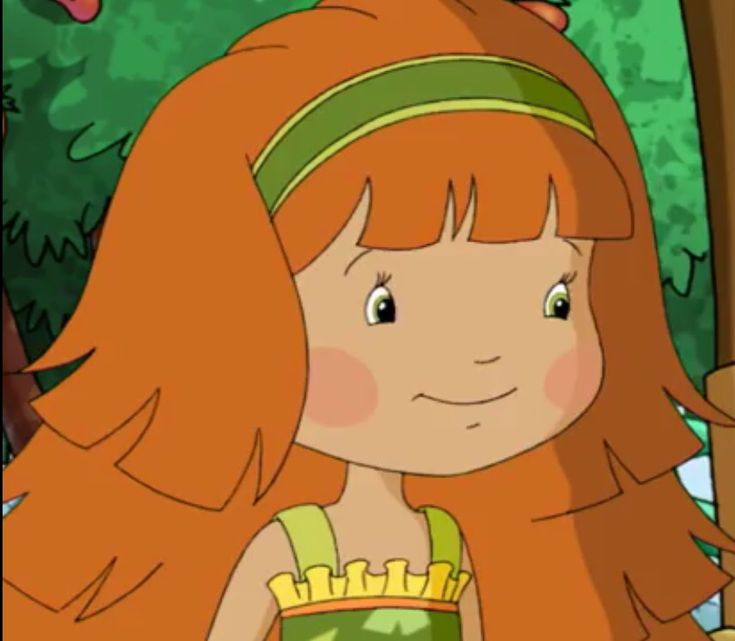 a girl with long red hair standing in front of a tree and holding a teddy bear