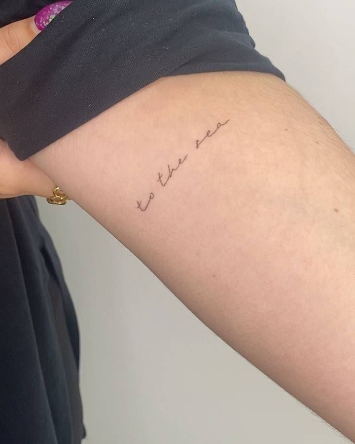 a woman's arm with the word love written on it