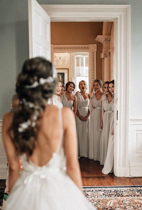 a bride and her bridal party in the mirror