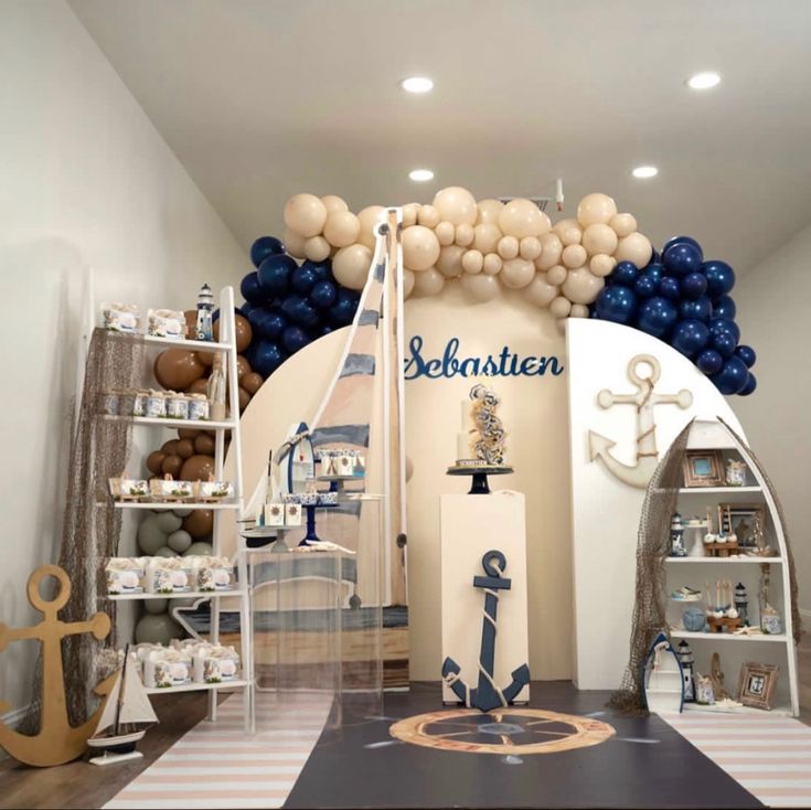 an ocean themed birthday party with balloons and decorations on the walls, along with blue and white decor