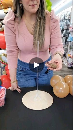 a woman standing in front of a table with doughnuts on it