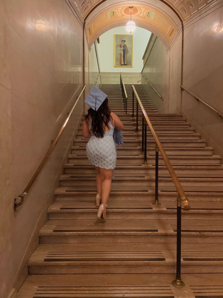 a woman walking up some stairs with an umbrella