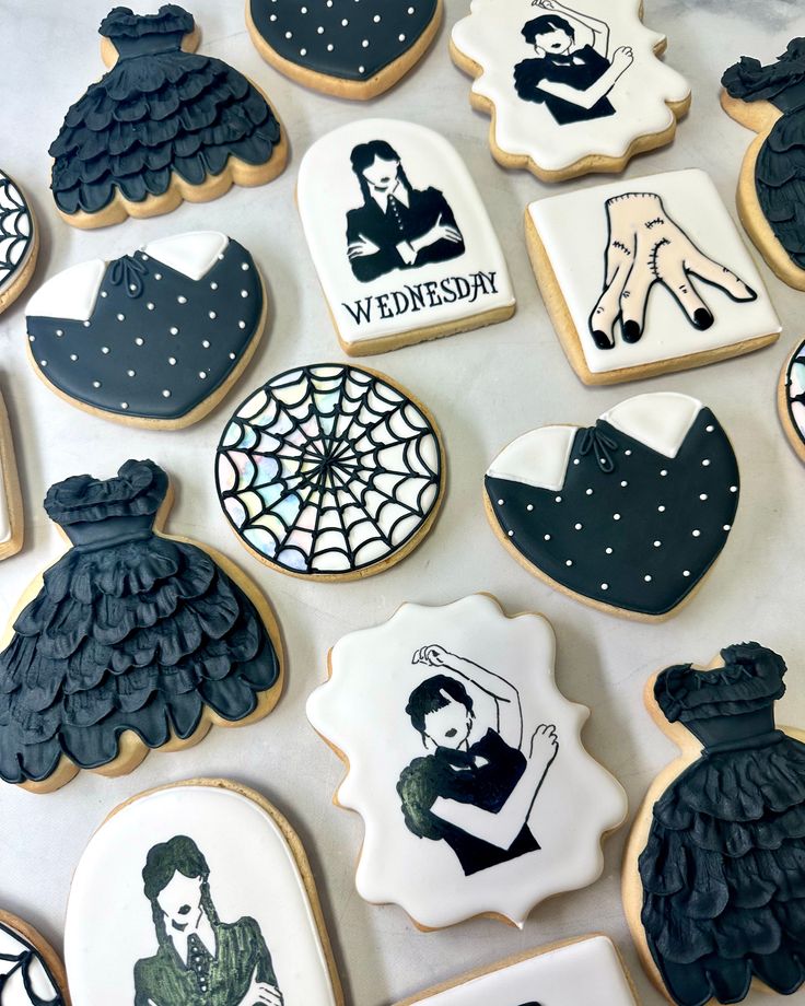 decorated cookies with black and white images on them, including women's dresses and men's stockings