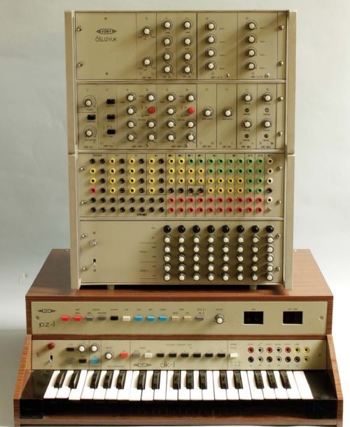 an old electronic organ sitting on top of a wooden stand with buttons and knobs