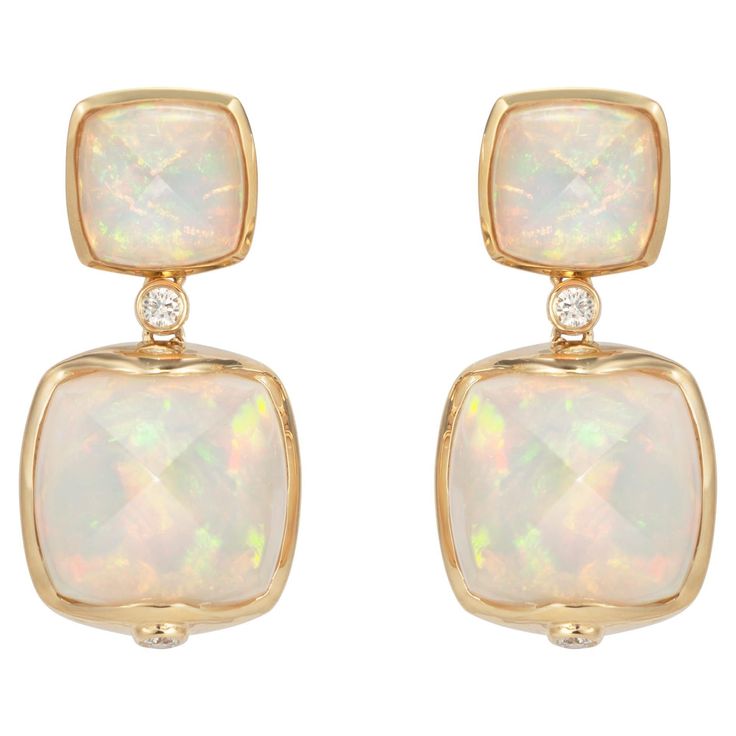 Sweet Sugarloaves! Light and easy to wear these earrings showcase beautiful sugarloaf gemstones accented with a gold frame and diamonds. These earrings are dainty yet have a great pop of color from the vibrant gems. Ethiopian Opal Sugarloaf Earrings with Diamond in 18 Karat Yellow Gold Ethiopian Opal: 2.95 carats, 8x8mm size, cushion sugarloaf cabochon, 2 pieces. Ethiopian Opal: 10.95 carats, 12x12mm size, cushion sugarloaf cabochon, 2 pieces. Diamond: 0.134 carats, round shape, G color VS clari Ethiopian Opal Earrings, Naha, Antique Earrings, Opal Earrings, Modern Earrings, Opal Jewelry, Pearl Drop Earrings, Modern Jewelry, Ethiopian Opal