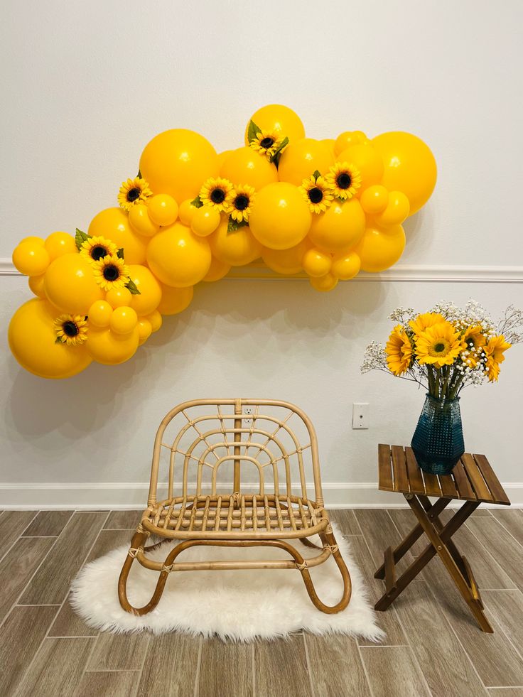 a bunch of yellow balloons are hanging on the wall