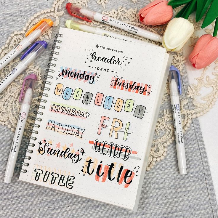 a notebook with some writing on it next to flowers and markers that say happy friday