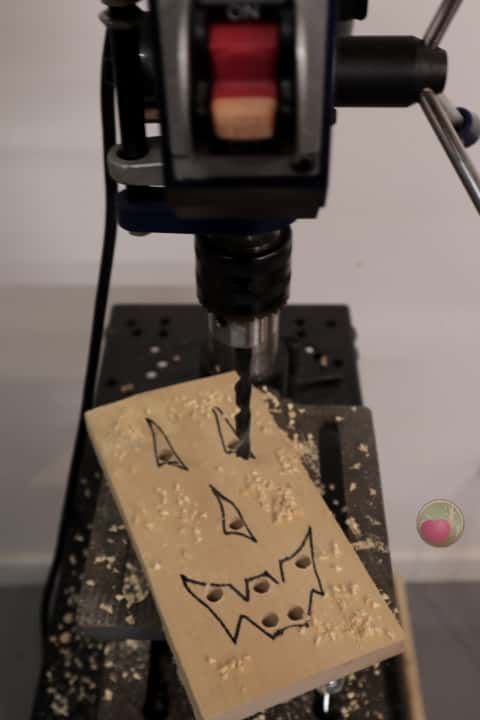 a small piece of paper with an animal drawn on it's side next to a machine