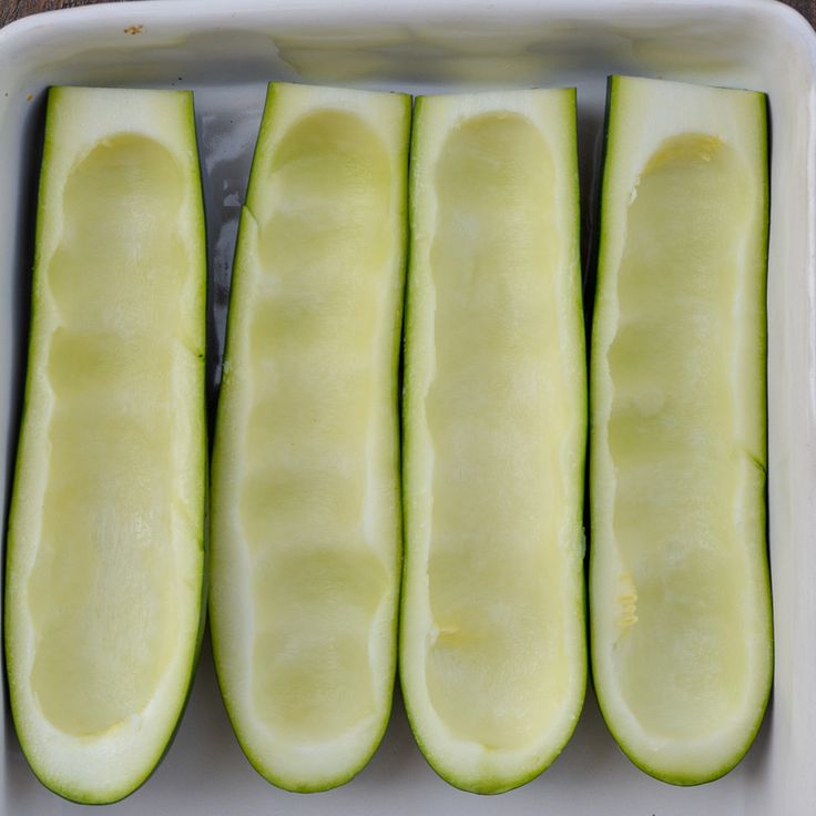 four slices of cucumber in a white dish